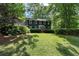 Traditional home with dark siding, white trim, and a well-maintained lawn in a picturesque neighborhood at 1435 Withmere Ln, Atlanta, GA 30338