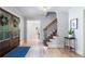 Welcoming foyer with hardwood floors, a staircase, and views into the adjacent living spaces at 1435 Withmere Ln, Atlanta, GA 30338