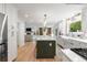 Open floor plan shows kitchen with island and view into the Gathering room beyond at 1435 Withmere Ln, Atlanta, GA 30338