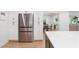 The kitchen offers stainless fridge, hardwood floors and plenty of cabinet space at 1435 Withmere Ln, Atlanta, GA 30338