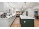 Kitchen features white cabinets, an island with bar seating, modern appliances, and a view to the dining room at 1435 Withmere Ln, Atlanta, GA 30338