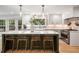 Bright kitchen features modern white cabinets, stainless appliances, and a large island with seating at 1435 Withmere Ln, Atlanta, GA 30338