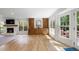 Bright living room with hardwood floors, fireplace, built-in cabinets, backyard views and access to the patio at 1435 Withmere Ln, Atlanta, GA 30338