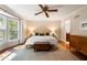 Cozy main bedroom features hardwood floors, ceiling fan, natural light, and ensuite bathroom at 1435 Withmere Ln, Atlanta, GA 30338