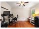 Home office setup with hardwood floors, desk, and exercise bike by a bright window at 1435 Withmere Ln, Atlanta, GA 30338