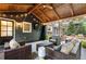Comfortable screened-in porch with outdoor tv, wicker seating, and patio area at 1435 Withmere Ln, Atlanta, GA 30338