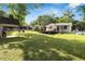 Spacious backyard showcasing the deck, ample green space, and mature trees, perfect for outdoor activities at 1608 Carroll Nw Dr, Atlanta, GA 30318