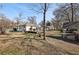 Vast backyard featuring a deck, storage building, and plenty of green space for outdoor activities and entertainment at 1608 Carroll Nw Dr, Atlanta, GA 30318