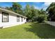 The house's side yard features a well-kept lawn, a white picket fence, and lush greenery, offering outdoor space at 1608 Carroll Nw Dr, Atlanta, GA 30318