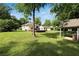 Expansive backyard with a deck, lush green lawn, and mature trees providing shade and privacy at 1608 Carroll Nw Dr, Atlanta, GA 30318