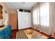 Bright bedroom with storage, hardwood floors, neutral walls, large windows, and colorful rugs at 1608 Carroll Nw Dr, Atlanta, GA 30318