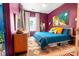 Cozy bedroom with colorful decor, a large bed, unique rug, and natural light from the window at 1608 Carroll Nw Dr, Atlanta, GA 30318