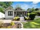 Beautifully landscaped home with a covered front porch, vibrant plants, and well-maintained lawn, exuding charm at 1608 Carroll Nw Dr, Atlanta, GA 30318