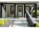 Inviting front porch with a striking teal door and ample seating area at 1608 Carroll Nw Dr, Atlanta, GA 30318