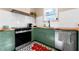 Close up of the kitchen featuring dark stainless steel oven and dishwasher, green cabinets, and wood countertops at 1608 Carroll Nw Dr, Atlanta, GA 30318