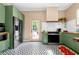 Well-appointed kitchen featuring green cabinetry and stainless steel appliances at 1608 Carroll Nw Dr, Atlanta, GA 30318