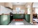 Bright kitchen with unique geometric tile floors, green cabinets, wood countertops, and stainless appliances at 1608 Carroll Nw Dr, Atlanta, GA 30318