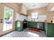 Cozy kitchen features green cabinets, wood counters, black and white patterned floors and door to backyard at 1608 Carroll Nw Dr, Atlanta, GA 30318