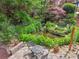 Serene backyard featuring a pond, small waterfall, lush landscaping, and a sitting area at 3282 Green Farm Trl, Dacula, GA 30019