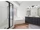 Bright bathroom featuring a walk-in shower, soaking tub, and double sink vanity at 3282 Green Farm Trl, Dacula, GA 30019