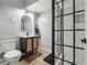 Modern bathroom featuring dark vanity, unique shower, and toilet at 3282 Green Farm Trl, Dacula, GA 30019