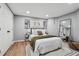 Bedroom with wood floor, large mirror, closet, and natural light at 3282 Green Farm Trl, Dacula, GA 30019
