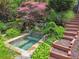 Secluded hot tub surrounded by landscaped greenery and stone accents at 3282 Green Farm Trl, Dacula, GA 30019