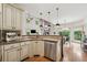 A bright kitchen featuring stainless steel appliances, wood floors, and stone countertops at 3282 Green Farm Trl, Dacula, GA 30019