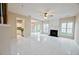 Open living room featuring tile floors, fireplace, and seamless transition to kitchen and backyard at 3601 Gainesway Trce, Duluth, GA 30096