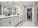 Bathroom featuring a double vanity with marble countertops, a glass shower, and modern lighting at 3652 Silvery Way, Powder Springs, GA 30127