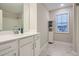 Bright bathroom featuring marble floors, white cabinets, and a combined shower and tub at 3652 Silvery Way, Powder Springs, GA 30127
