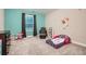 Bedroom featuring a butterfly toddler bed, a chair, and playful wall decorations at 3652 Silvery Way, Powder Springs, GA 30127