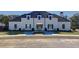Elegant community clubhouse with a symmetrical facade, landscaped entrance, and decorative benches at 3652 Silvery Way, Powder Springs, GA 30127