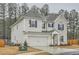 Spacious home showcasing a two-car garage, brick accents and clean siding with complementary blue shutters at 3652 Silvery Way, Powder Springs, GA 30127