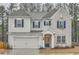 Charming two-story home featuring brick and siding exterior with blue shutters and a well-manicured lawn at 3652 Silvery Way, Powder Springs, GA 30127