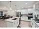 Modern kitchen featuring white cabinetry, stainless steel appliances, and a spacious center island at 3652 Silvery Way, Powder Springs, GA 30127