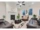 Relaxing living room showcasing a fireplace, leather seating, and abundant natural light at 3652 Silvery Way, Powder Springs, GA 30127