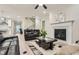 Cozy living room featuring a fireplace, comfortable leather seating, and access to other living spaces at 3652 Silvery Way, Powder Springs, GA 30127