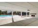 Spacious pool house with an outdoor fireplace and open sides, perfect for lounging poolside at 3652 Silvery Way, Powder Springs, GA 30127