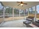 A screened in porch offers an outdoor seating area with views of the large, fenced backyard at 3652 Silvery Way, Powder Springs, GA 30127