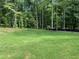 Lush backyard with grass and mature trees at 5907 Sw Bunting Ln, Atlanta, GA 30331