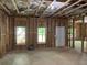 Unfinished basement with exposed beams, windows, and a door at 5907 Sw Bunting Ln, Atlanta, GA 30331