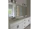 Elegant bathroom featuring a double vanity with white cabinets and modern fixtures at 5907 Sw Bunting Ln, Atlanta, GA 30331