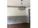 Elegant dining room with decorative molding, modern chandelier, and hardwood floors at 5907 Sw Bunting Ln, Atlanta, GA 30331
