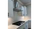Modern kitchen features stainless steel range hood, white cabinets, and sleek black hardware at 5907 Sw Bunting Ln, Atlanta, GA 30331