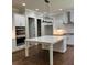 Modern kitchen with white cabinets, stainless steel appliances, a large island, and hardwood floors at 5907 Sw Bunting Ln, Atlanta, GA 30331