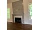 Cozy living room featuring a fireplace with a decorative mantle and large windows at 5907 Sw Bunting Ln, Atlanta, GA 30331