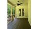 Outdoor patio featuring a ceiling fan, wood floors, and forest views at 5907 Sw Bunting Ln, Atlanta, GA 30331