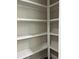 Bright walk-in closet featuring custom white shelving for optimal storage and organization at 5907 Sw Bunting Ln, Atlanta, GA 30331