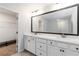 Bathroom featuring a large vanity with dual sinks, an oversized mirror, and a view into the walk-in closet at 1227 Herty Dr, Marietta, GA 30062